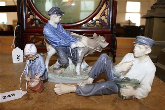 Royal Copenhagen boy with calf group and two other figures